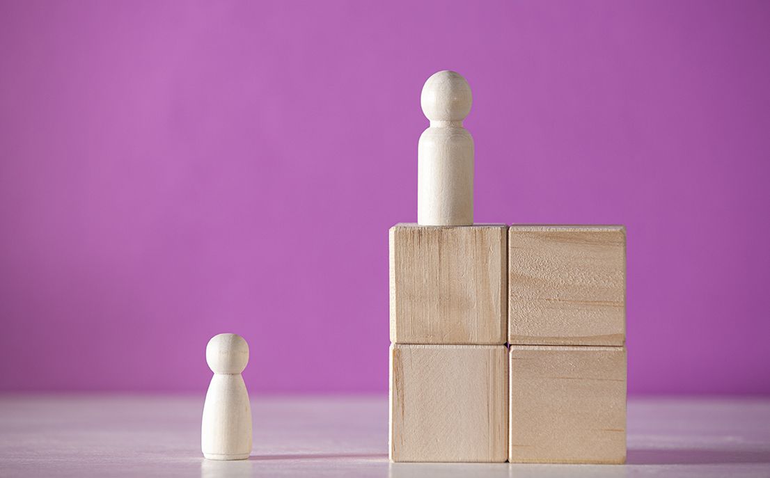 Two wooden blocks with a person standing on top of them.