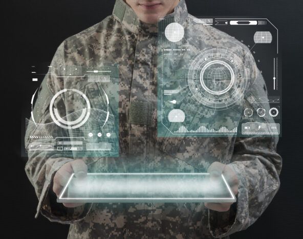 A soldier is holding a tablet displaying a futuristic image, enhancing the experience with innovative design offerings.