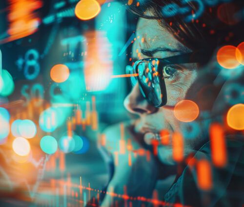 Person wearing glasses looks at digital financial data with charts and numbers overlaid, representing data analysis or stock market trends.