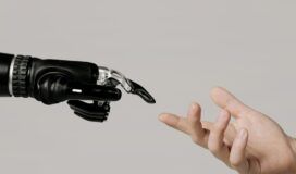 A robotic hand and a human hand reach towards each other against a neutral background.